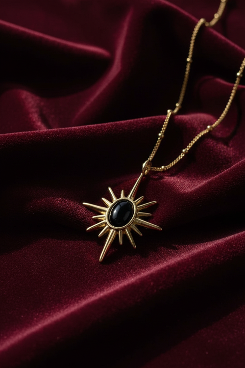 Gold Sunburst Black Onyx Pendant – Burgundy Background